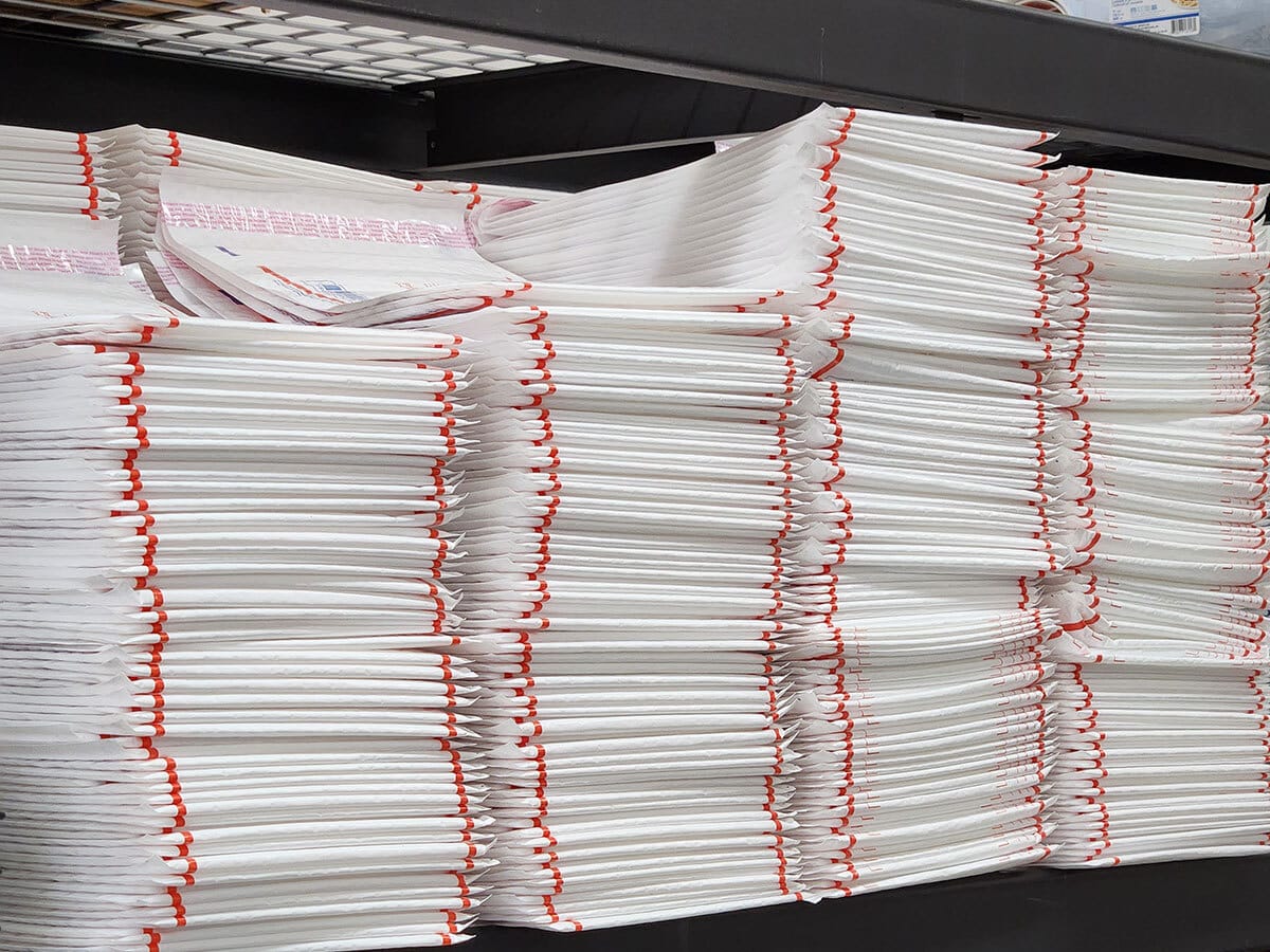 large mailing envelopes stacked on shelf